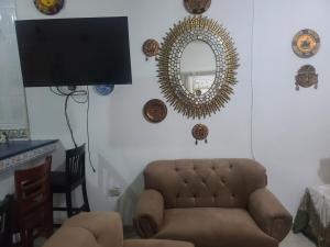 a living room with a couch and a mirror at Casa de tres Unique Welcoming Familiar in San Miguel