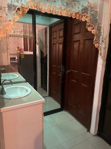 a bathroom with a sink and a wooden door at Casa de tres Unique Welcoming Familiar in San Miguel +10 photos