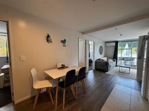 a dining room and living room with a table and chairs at Park Views, Close to town in Queenstown