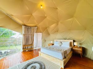 a bedroom in a tent with a bed in it at De'Ra Hills Camp Kintamani in Kintamani