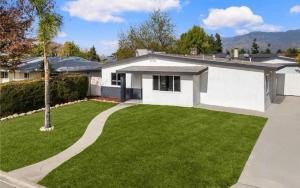 a white house with a green yard at Cozy beautiful house in Glendora +11 photos