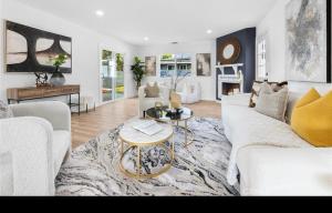 a living room with a white couch and a table at Cozy beautiful house in Glendora