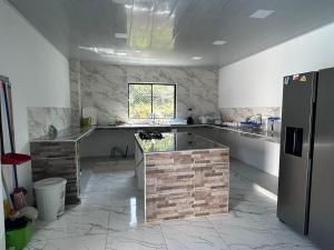 a kitchen with a counter and a refrigerator at Quinta Leal in Melgar