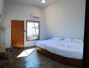 a bedroom with a large bed and a window at Asia Rainforest Resort in Semporna