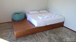 a bed with two white lilies on top of it at Asia Rainforest Resort in Semporna