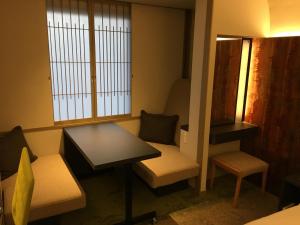 a room with a table and a table and chairs at ANA Crowne Plaza Hotel Kyoto by IHG in Kyoto