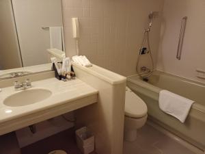 a bathroom with a sink and a toilet and a tub at ANA Crowne Plaza Hotel Kyoto by IHG in Kyoto