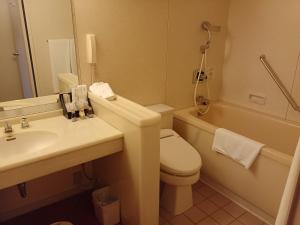 a bathroom with a toilet and a sink and a tub at ANA Crowne Plaza Hotel Kyoto by IHG in Kyoto