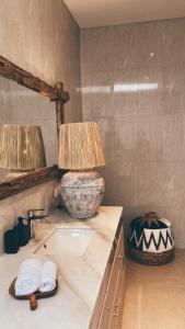 a bathroom with a sink and two lamps on a counter at Villa Hope Bali in Kerobokan +13 photos