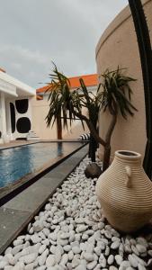 a large vase sitting next to a swimming pool at Villa Hope Bali in Kerobokan