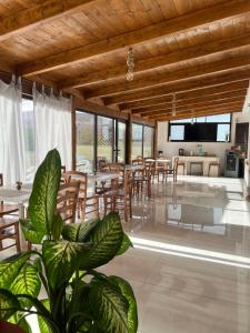 a living room with wooden ceilings and a dining room at Villa Delle Rose in Naples