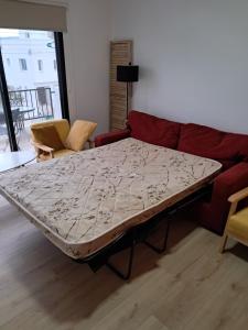 a large bed in a living room with a couch at Apartment with sea view! in Khlorakas