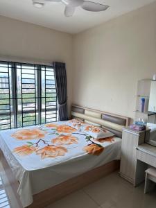 a bedroom with a large bed with orange flowers on it at OUG Parklane Block A1 in Kuala Lumpur