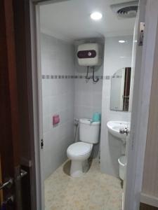 a small bathroom with a toilet and a sink at For rent or sale Puncak Kertajaya apartment in Surabaya