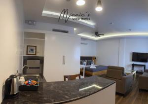 a room with a kitchen and a living room at Minnie's Guest House in Taytay