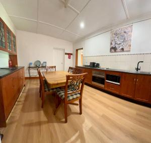 a large kitchen with a wooden table and chairs at Wild Hearts Cottage in Wallaroo