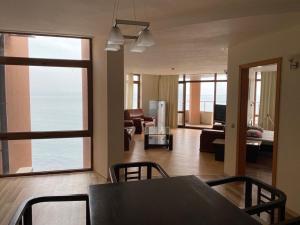 a living room with a table and chairs and a living room at Sozopol Sunrise A in Sozopol