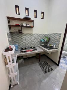 a kitchen with a sink and a counter top at Parkside nest-studio 3 in Kuta Lombok
