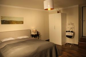 a bedroom with a bed and a white cabinet at SALITEREI Ferienhaus im Herzen des Seewinkels in Frauenkirchen