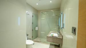 a bathroom with a shower and a toilet and a sink at Aram Hotel - AlMeshael Exit 18 in Riyadh
