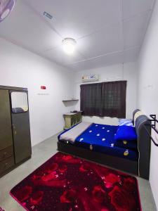 a bedroom with a bed and a red carpet at Orchid Homestay Pasir Gudang in Pasir Gudang