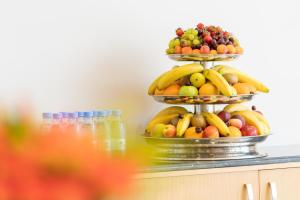 two tiers of fruit on top of a counter at Aram Hotel - AlMeshael Exit 18 in Riyadh