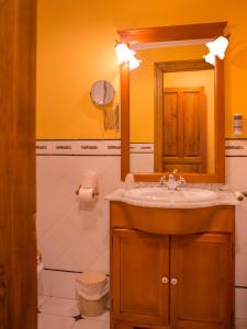 a bathroom with a sink and a mirror at Hosteria Los Laureles in Noja +28 photos