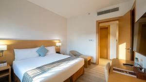 a hotel room with a bed and a television at Aram Hotel - AlMeshael Exit 18 in Riyadh