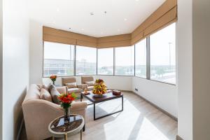 a living room with a couch and a table at Aram Hotel - AlMeshael Exit 18 in Riyadh