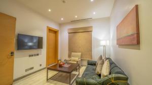 a living room with a couch and a table at Aram Hotel - AlMeshael Exit 18 in Riyadh