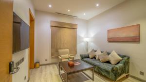a living room with a couch and a table at Aram Hotel - AlMeshael Exit 18 in Riyadh