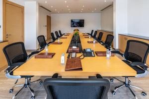 a large conference room with a long table and chairs at Aram Hotel - AlMeshael Exit 18 in Riyadh