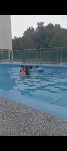 a group of people in a pool of water at Pemandangan tepi pantai rumah keluarga 6pax in Kuantan