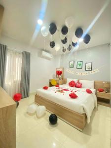 A bed or beds in a room at Luna House Hotel