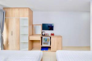A bed or beds in a room at Luna House Hotel