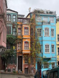 a tall building with lots of windows on a street at Stunning Private House in Balat in Istanbul