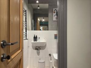 a bathroom with a sink and a toilet and a mirror at Stunning Private House in Balat in Istanbul +18 photos