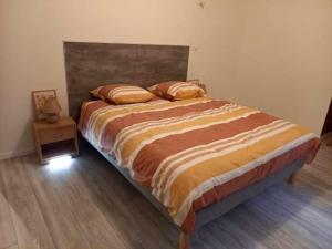 a bedroom with a large bed with a wooden floor at PàM DUROC in Pont-à-Mousson