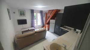 a living room with a couch and a television at Chez Aldo in Ajaccio