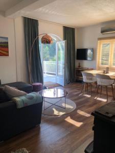 a living room with a couch and a table at Sokograd Loft in Šipovo