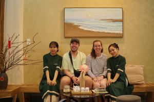 a group of people sitting on a couch at Hue Sweethouse 2 Homestay in Hue