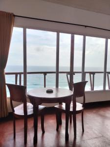 a table and chairs in a room with a view of the ocean at Nunggalan Octopus 2 in Uluwatu