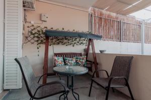 a table and two chairs on a porch with a table and chairs at Spyridoula's apartment in Nafplio
