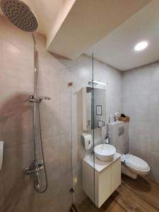 a bathroom with a shower and a sink and a toilet at Foxxy Luxury Apartments in Skopje