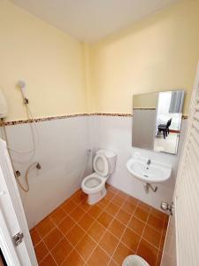 a bathroom with a toilet and a sink at Bansuanrimnam Pakchong Resort in Pak Chong +36 photos