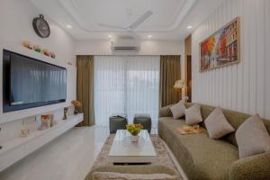 a living room with a couch and a tv at Cuddle Corner -Embrace Cuteness in North goa
