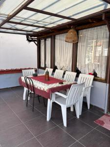 a dining table and chairs on a patio with a table and chairs at Kimon Penthouse in Thessaloniki