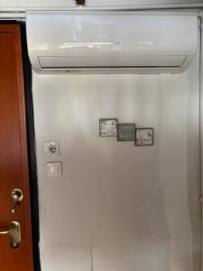 a white refrigerator with four pictures on it at Kimon Penthouse in Thessaloniki