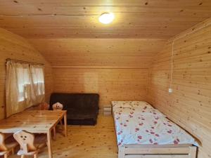 En eller flere senge i et værelse på POD FALAMI - domki letniskowe