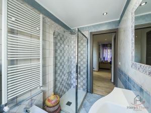 a bathroom with a glass shower and a sink at San Paolo Hospital 2mins - HiperWifi - SmartTV - AC in Savona +33 photos
